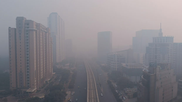 Photograph of a city covered in smog caused by the burning of fossil fuels
