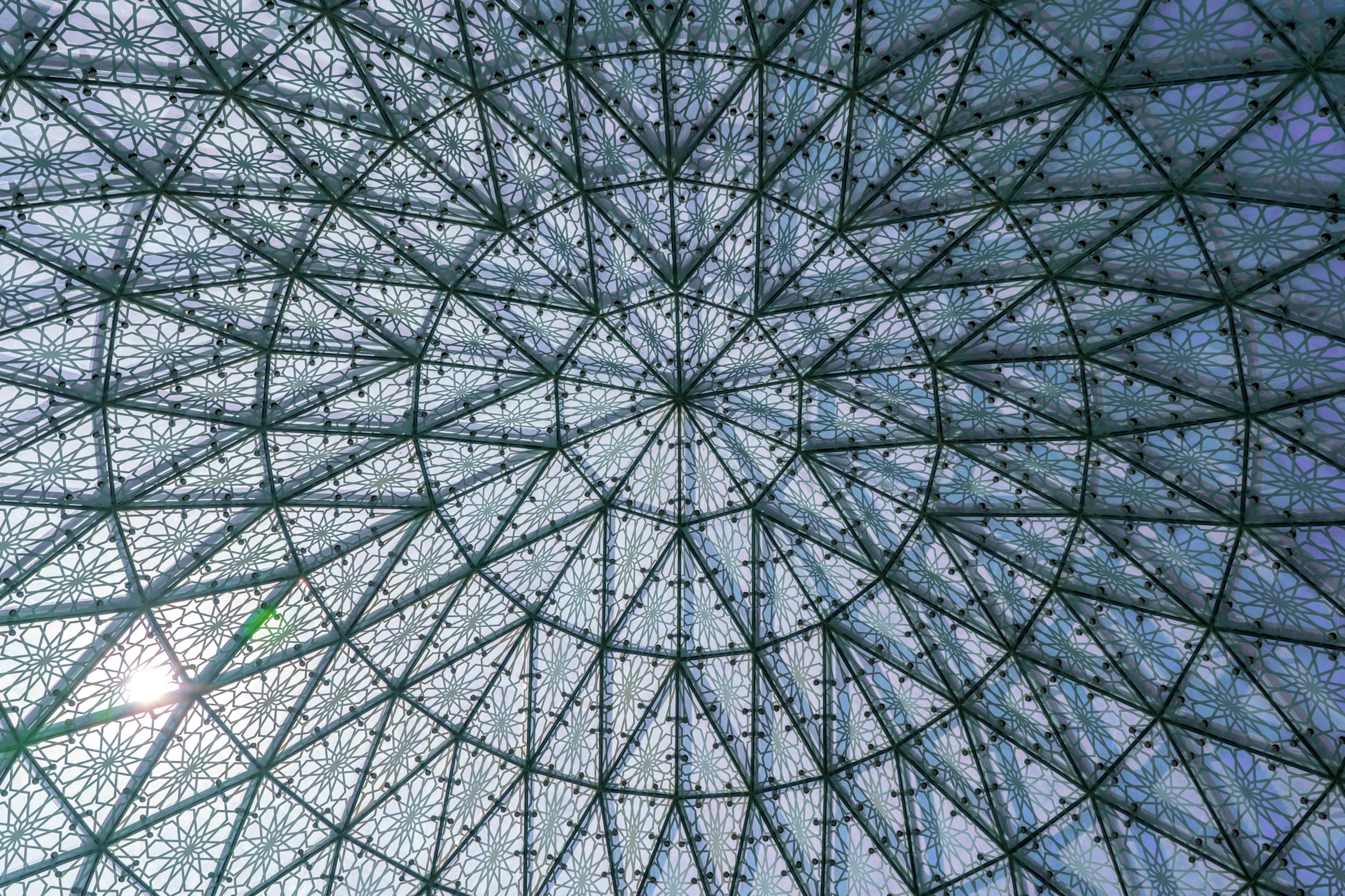 Photograph of an intricately patterned glass dome, taken from underneath