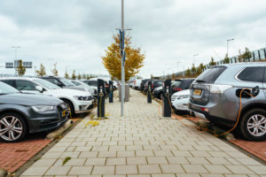 Rows of EVs charging at a public charging station