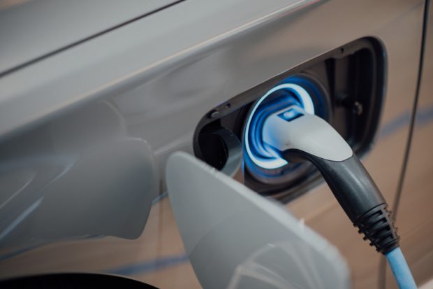 Close-up of the charging point in an electric car with the charger plugged in