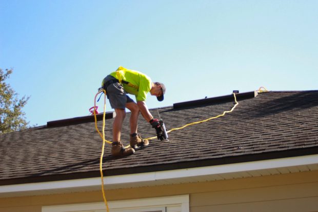 Man installing solar panels on a roof