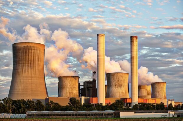 Wide shot of generic coal power station spewing toxic chemicals into the air