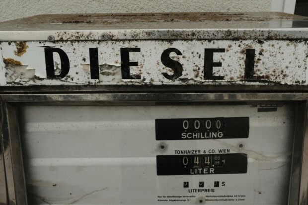 Close-up of a rusty old pump for fuelling diesel cars. It says DIESEL across the top in big letters and the smaller writing on it is in German. 