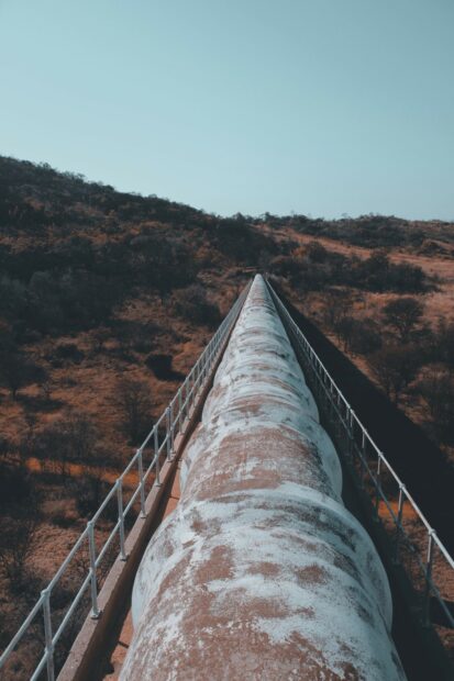 Natural gas pipeline on a bridge over scrubland somewhere in South Africa.